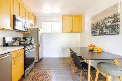 a kitchen with a table with chairs and a counter top at Serene and beautiful hillside retreat in Glendale