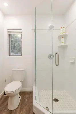 a bathroom with a toilet and a glass shower at Serene and beautiful hillside retreat in Glendale