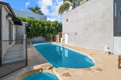 a swimming pool in front of a building at Elegance Escape Sleeps 10 Pool with Jacuzzi in Los Angeles