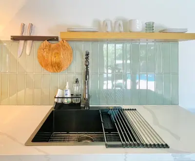 a kitchen with a sink and a counter top at Sunny Days Tiny House with private entrance, pool and view in West Covina