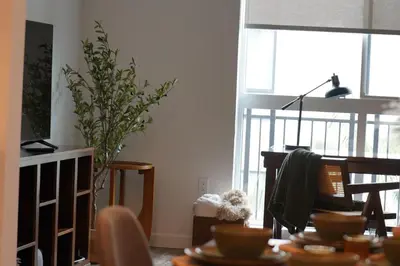 a living room with a table and a tv at Hollywood CHIC Studio with FREE parking in Los Angeles