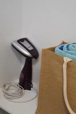 a phone on a stand next to a bag at Hollywood CHIC Studio with FREE parking in Los Angeles