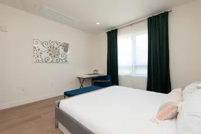 a bedroom with a white bed and a window at Stylish Apartments in Glendale with Free Parking in Glendale