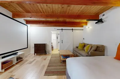 a bedroom with a bed and a flat screen tv at Quiet Wooded Retreat in Lake Arrowhead