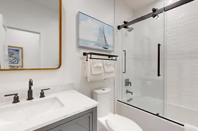 a bathroom with a sink and a toilet and a shower at Mickey's Hideaway in Anaheim