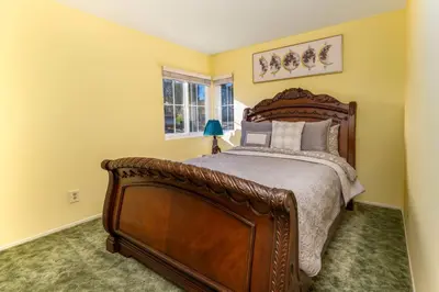 a bedroom with a large wooden bed and a window at The Best View in The City! in Castaic