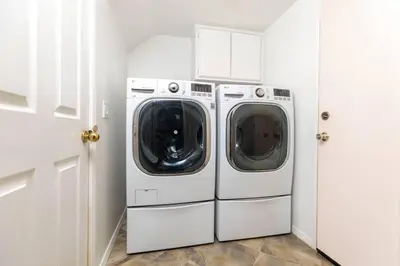 a white laundry room with a washer and dryer at The Best View in The City! in Castaic