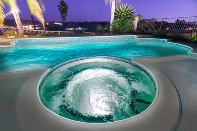 a large swimming pool with a green water at The Best View in The City! in Castaic