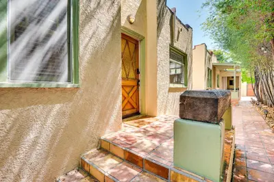 a door to a house with a suitcase in front of it at Less Than 1 Mi to Venice Beach and Boardwalk! Quiet Cottage in Los Angeles