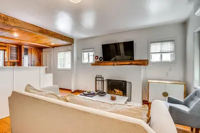 a living room with a couch and a fireplace at Less Than 1 Mi to Venice Beach and Boardwalk! Quiet Cottage in Los Angeles