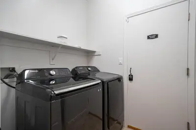 a washer and dryer in a small room at Central Bliss near parks & shops in Bakersfield