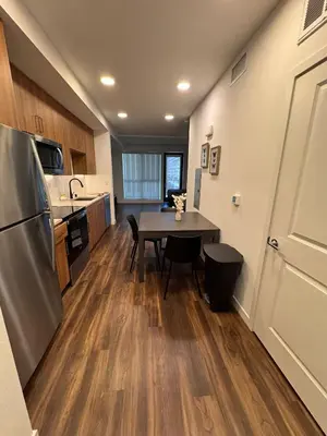 a small kitchen with a table and a refrigerator at Awesome Loft at Hollywood FREE Parking in Los Angeles
