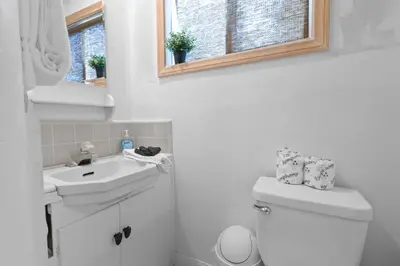 a bathroom with a sink and a toilet and a mirror at Cozy Bear Cottage - Walk to Lake & Village! in Big Bear Lake