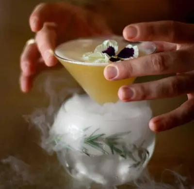 a person holding a cup on top of a vase at Cozy Resort-Style Experience - Garden View in Los Angeles