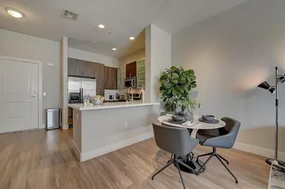 a kitchen and dining room with a table and chairs at Penthouse One Bedroom Garden View Condo by UCLA in Los Angeles