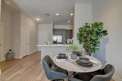 a kitchen and dining room with a table and chairs at Penthouse One Bedroom Garden View Condo by UCLA in Los Angeles