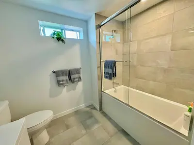 a bathroom with a shower and a toilet and a tub at Corner 2 Bedroom 2 Bath Condo - Balcony - Parking in Los Angeles