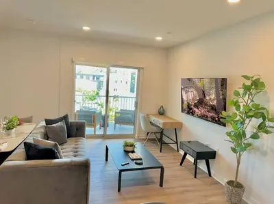 a living room with a couch and a table at Corner 2 Bedroom 2 Bath Condo - Balcony - Parking in Los Angeles