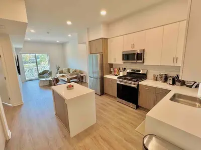 a kitchen with white cabinets and a stove top oven at Designer Silver Lake Stylish One Bedroom with Parking in Los Angeles