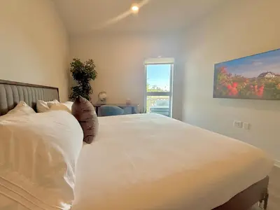 a bedroom with a large white bed with a window at Designer Silver Lake Stylish One Bedroom with Parking in Los Angeles
