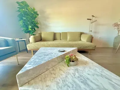 a living room with a couch and a table at Designer Silver Lake Stylish One Bedroom with Parking in Los Angeles