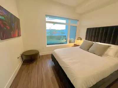 a bedroom with a large bed and a window at Luxe Corner One Bedroom, Prime Hollywood with Parking in Los Angeles