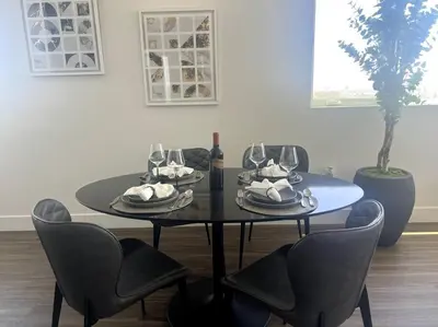 a black table with chairs and wine glasses on it at Luxe Corner One Bedroom, Prime Hollywood with Parking in Los Angeles