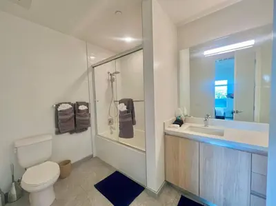 a bathroom with a toilet and a sink and a shower at Luxe Corner One Bedroom, Prime Hollywood with Parking in Los Angeles
