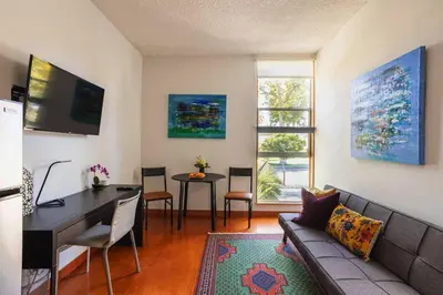 a living room with a couch and a table at Lovely one bedroom guest house in Encino village in Los Angeles