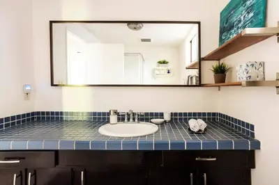 a bathroom with a sink and a mirror at Lovely one bedroom guest house in Encino village in Los Angeles
