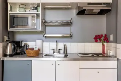 a kitchen with a sink and a microwave at Lovely one bedroom guest house in Encino village in Los Angeles