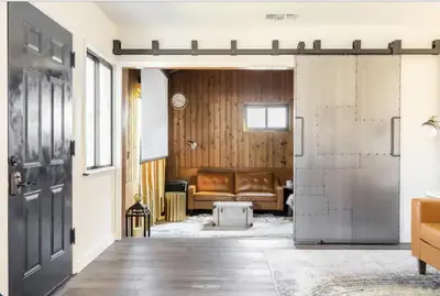 an open door into a living room with a couch at Party House Heaven in North Hollywood