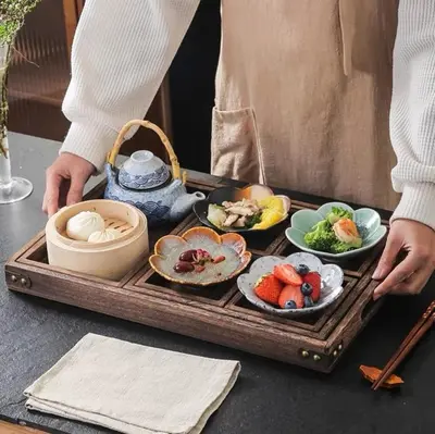 a person holding a tray of food on a table at Party House Heaven in North Hollywood