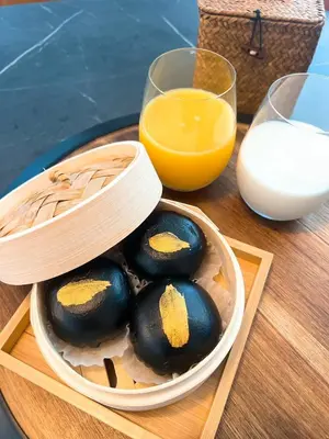 a bowl of eggs and a glass of orange juice at Party House Heaven in North Hollywood