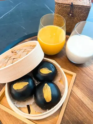 a bowl of eggs and a glass of orange juice at Party House Heaven in North Hollywood