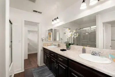 a bathroom with two sinks and a large mirror at Perfect Home for Work or Relaxing Vacation in Bakersfield