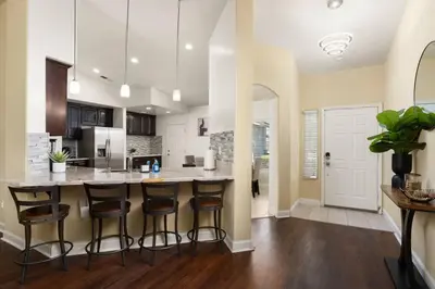 a kitchen with a large island with bar stools at Perfect Home for Work or Relaxing Vacation in Bakersfield
