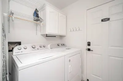 a white laundry room with a washer and dryer at Simple Home for Work or Travel in Bakersfield