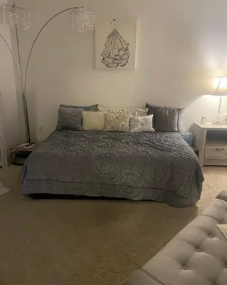 a bedroom with a large bed with pillows at Tucked in Little Tokyo in Los Angeles