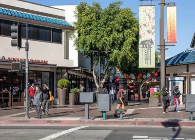 a group of people walking on a city street at Tucked in Little Tokyo in Los Angeles
