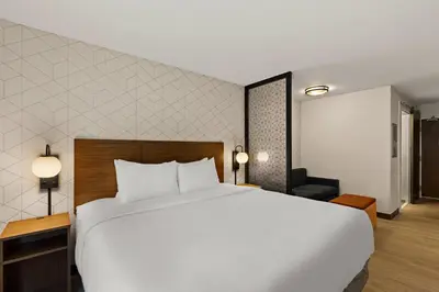 a large white bed in a hotel room at Everhome Suites Ontario in Ontario