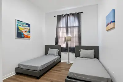 two beds in a room with a window at Lovely gated 3bedroom & 2 bath unit near Universal studio and Hollywood in North Hollywood