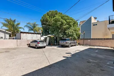 two cars are parked in a parking lot at Lovely gated 3bedroom & 2 bath unit near Universal studio and Hollywood in North Hollywood