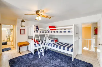 a bedroom with two bunk beds and a ceiling fan at Pet-Friendly Riverside Retreat with Private Spa! in Riverside
