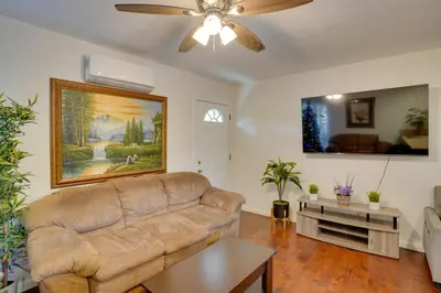 a living room with a couch and a table at 5 Mi to Coast Centrally Located Long Beach Home! in Long Beach