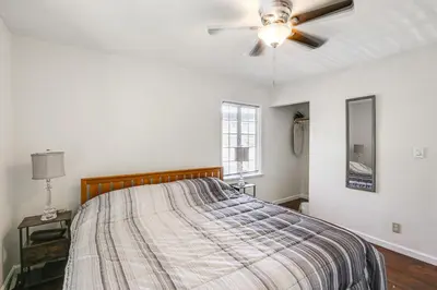 a bedroom with a bed and a ceiling fan at 5 Mi to Coast Centrally Located Long Beach Home! in Long Beach