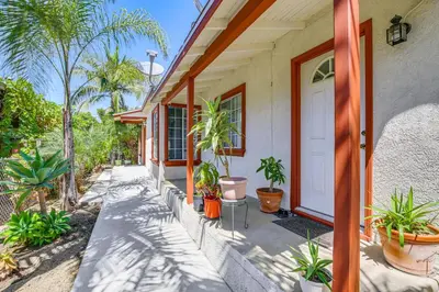 a house with plants on the side of it at 5 Mi to Coast Centrally Located Long Beach Home! in Long Beach