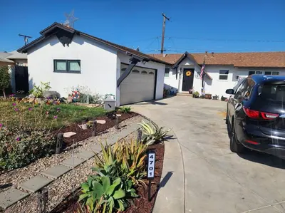 a car parked in front of a house at The Coastal Comfort in Oxnard