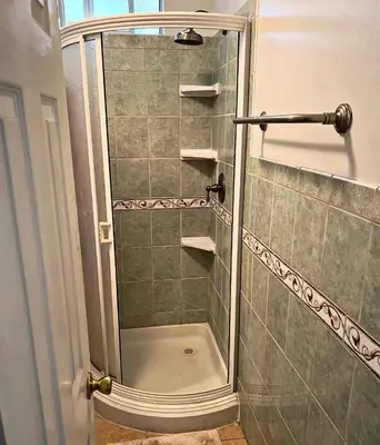 a shower with a glass door in a bathroom at The Hub in Del Aire