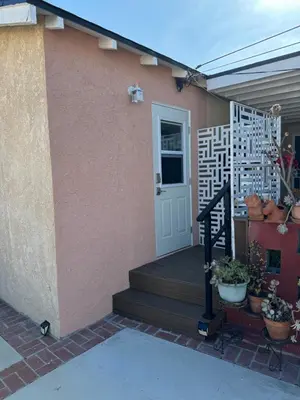 a house with a porch with a white door at The Hub in Del Aire